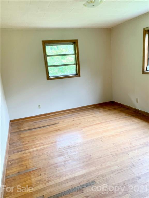 379 South Goforth Road Ferguson, NC 28624 - Photo 13 of 16 a view of empty room with window and wooden floor