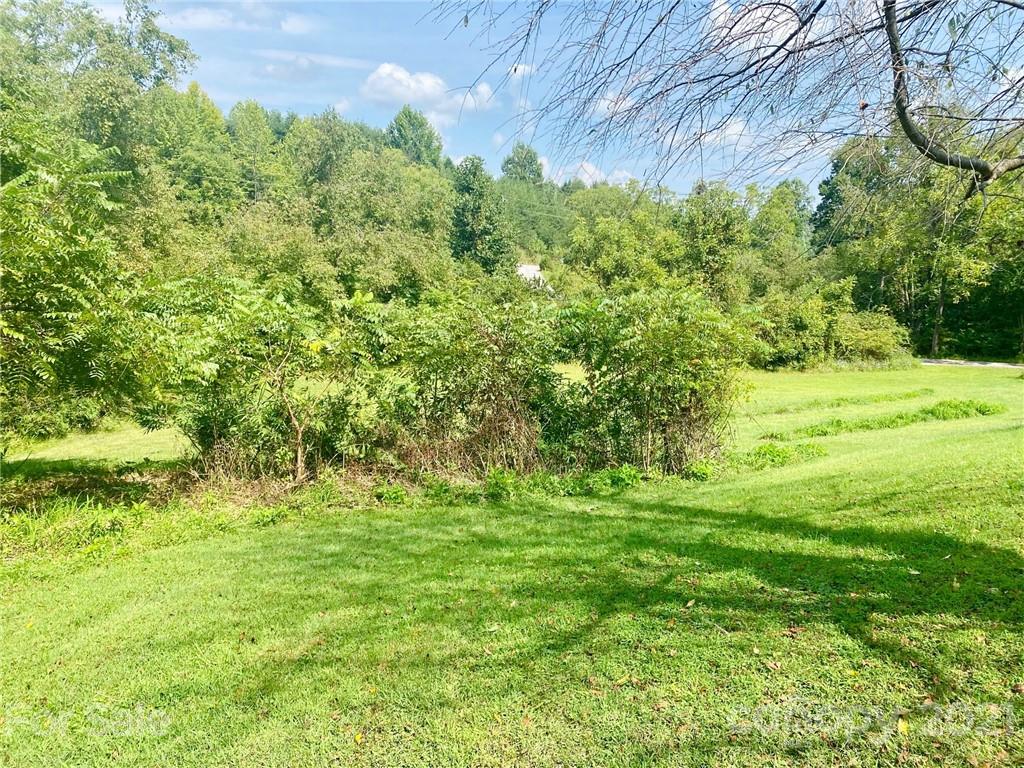 379 South Goforth Road Ferguson, NC 28624 - Photo 14 of 16 a backyard of a building with trees in the background
