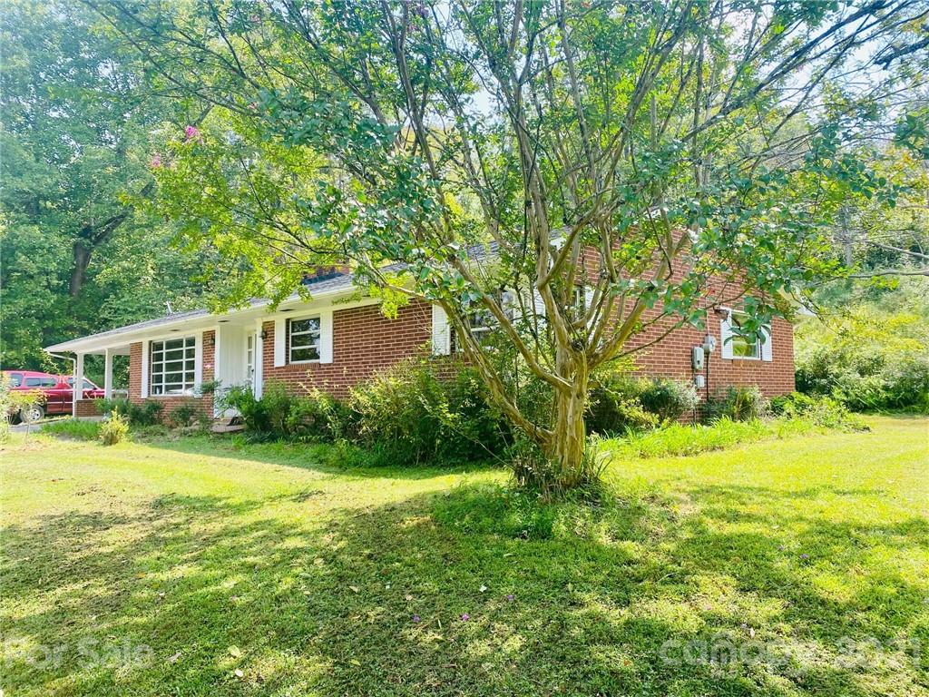 379 South Goforth Road Ferguson, NC 28624 - Photo 15 of 16 a front view of a house with a yard and trees