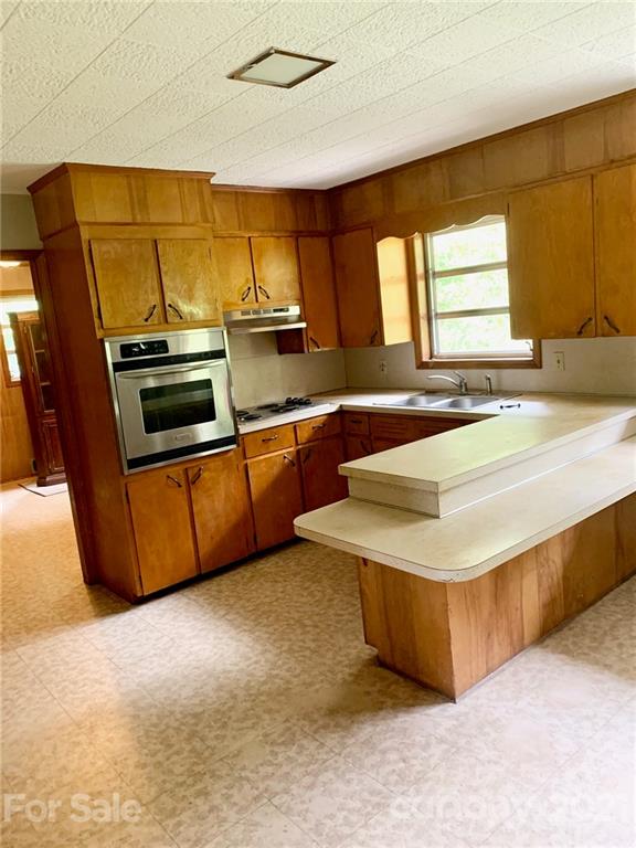 379 South Goforth Road Ferguson, NC 28624 - Photo 7 of 16 a kitchen with stainless steel appliances granite countertop a sink and a stove