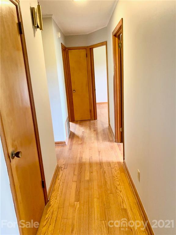 379 South Goforth Road Ferguson, NC 28624 - Photo 9 of 16 a view of a hallway with wooden floor and stairs