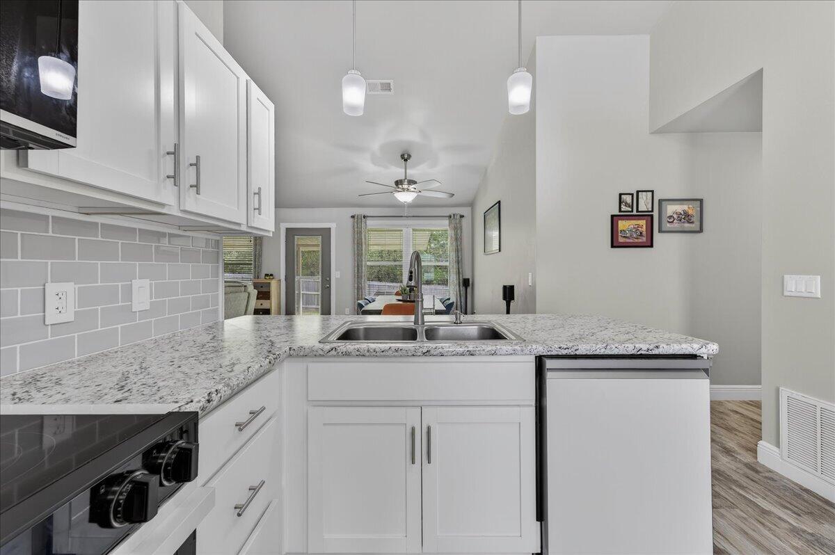 5328 Whitney Court Crestview, FL 32536 - Photo 21 of 48 a kitchen with a sink stove and cabinets