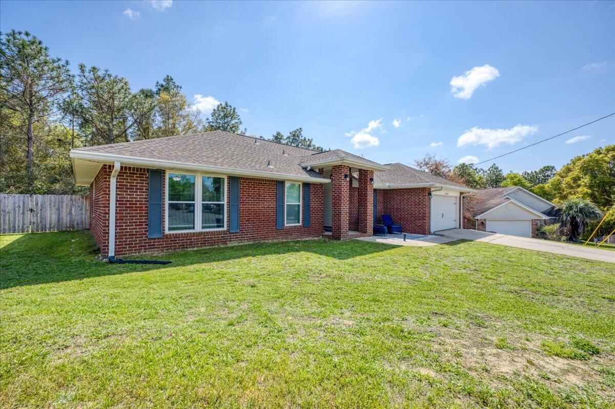 5328 Whitney Court Crestview, FL 32536 - Photo 3 of 48 a front view of a house with a garden