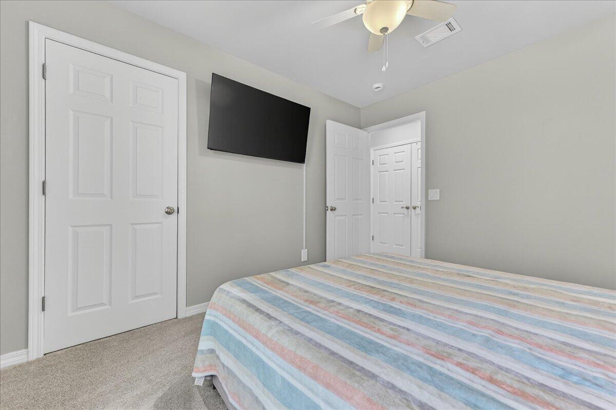 5328 Whitney Court Crestview, FL 32536 - Photo 33 of 48 a bedroom with a bed and a chandelier