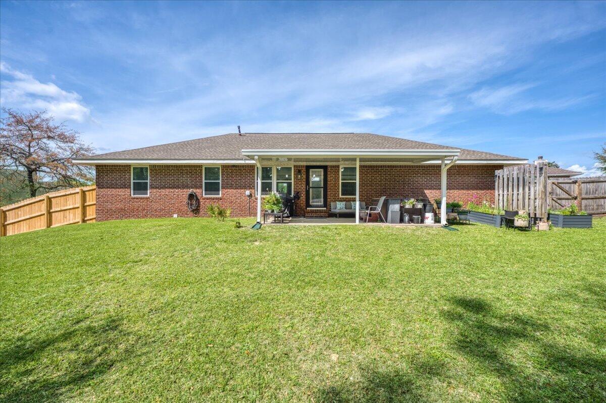 5328 Whitney Court Crestview, FL 32536 - Photo 44 of 48 a view of a house with a backyard porch and sitting area
