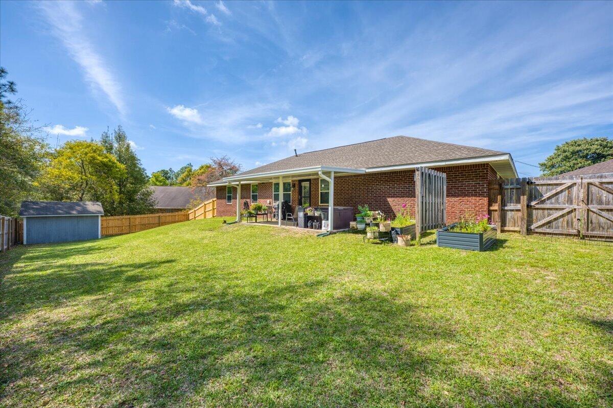 5328 Whitney Court Crestview, FL 32536 - Photo 48 of 48 a view of a house with backyard porch and garden