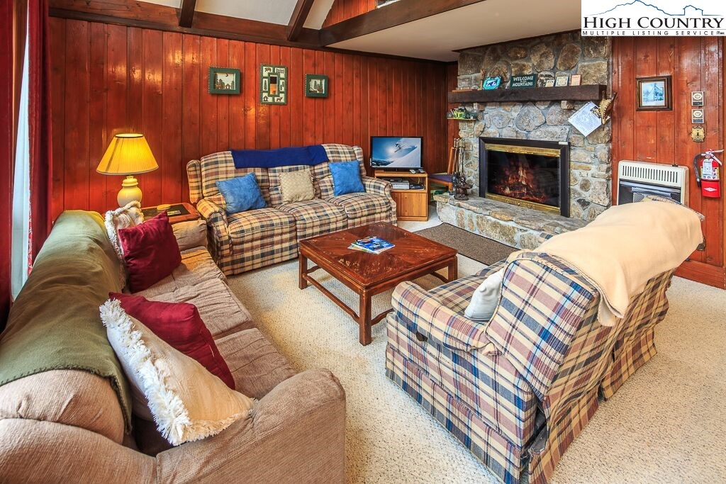 105 North Pinnacle Ridge Road, Unit MNC I # 7 Beech Mountain, NC 28604 - Photo 1 of 39 a living room with furniture and a fireplace