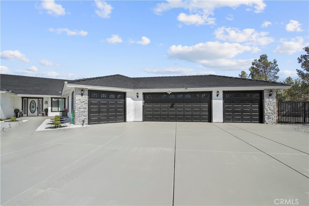 12909 Casco Road Apple Valley, CA 92308 - Photo 1 of 1 a front view of a house with a yard and garage