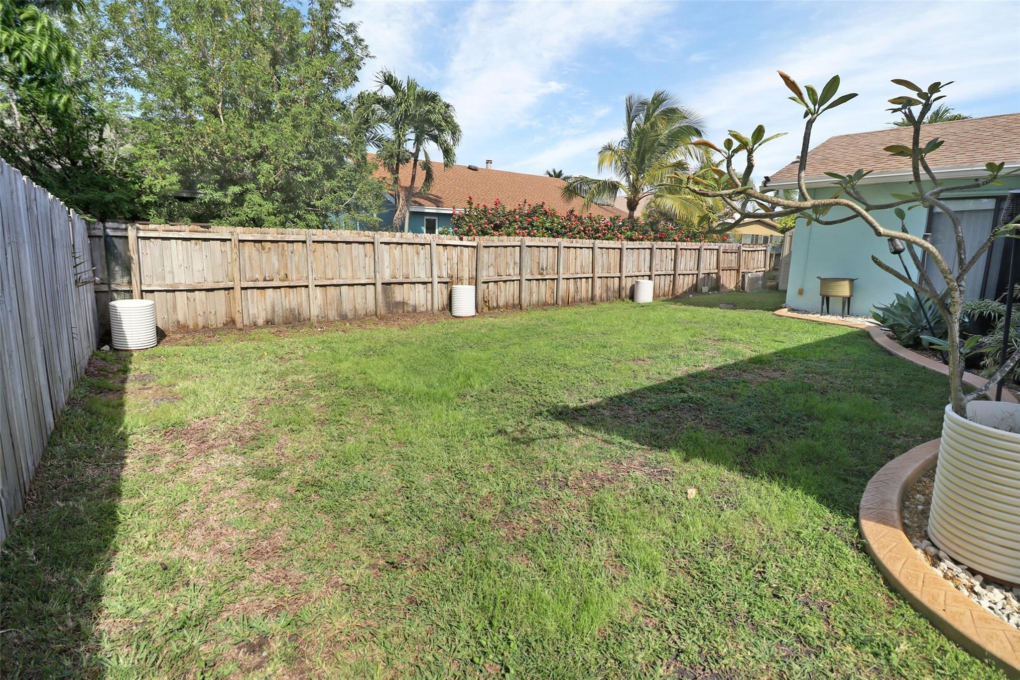 231 Southeast 9th Street Dania Beach, FL 33004 - Photo 12 of 27 a view of a backyard with a garden and deck in the back