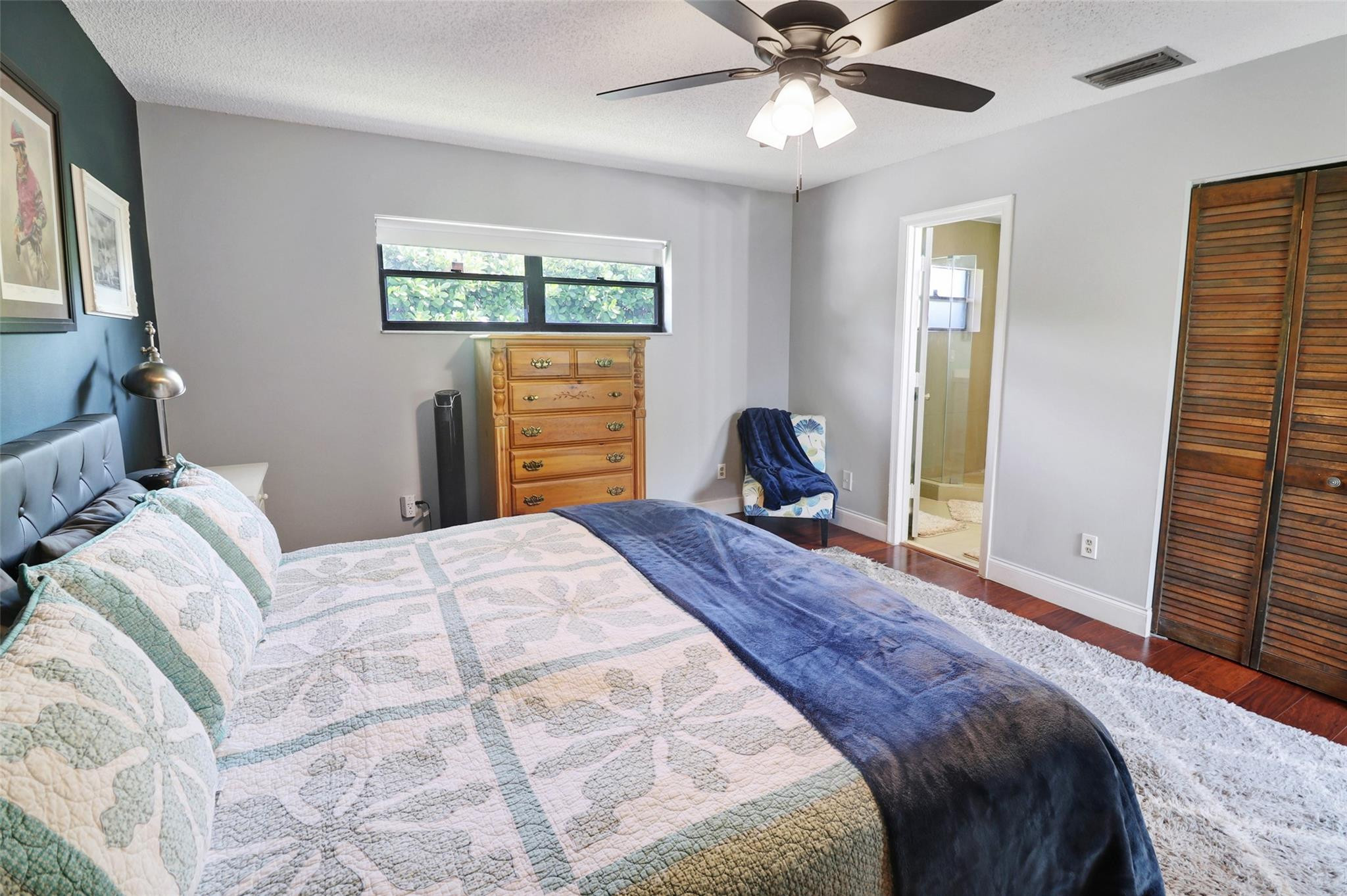 231 Southeast 9th Street Dania Beach, FL 33004 - Photo 20 of 27 a bedroom with a bed and a chandelier