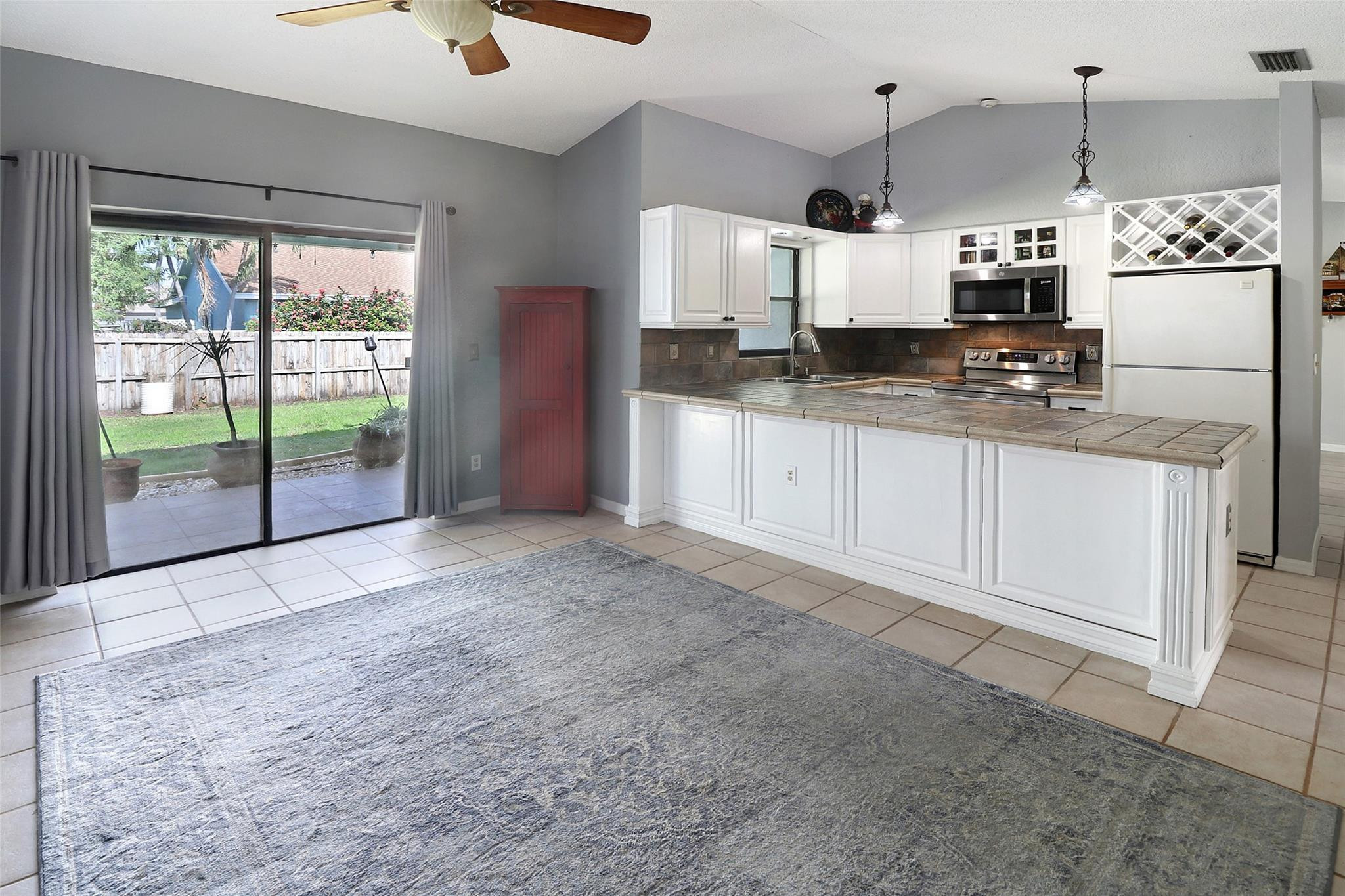231 Southeast 9th Street Dania Beach, FL 33004 - Photo 5 of 27 a large kitchen with granite countertop a sink and a refrigerator