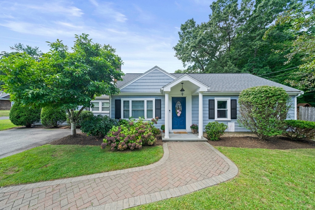 a front view of a house with a yard and porch