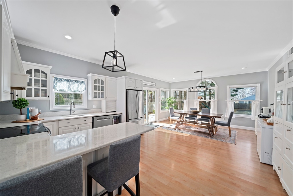 54 Birchcroft Road Canton, MA 02021 - Photo 16 of 37 a very nice looking kitchen with granite countertop a stove a sink a dining table and chairs