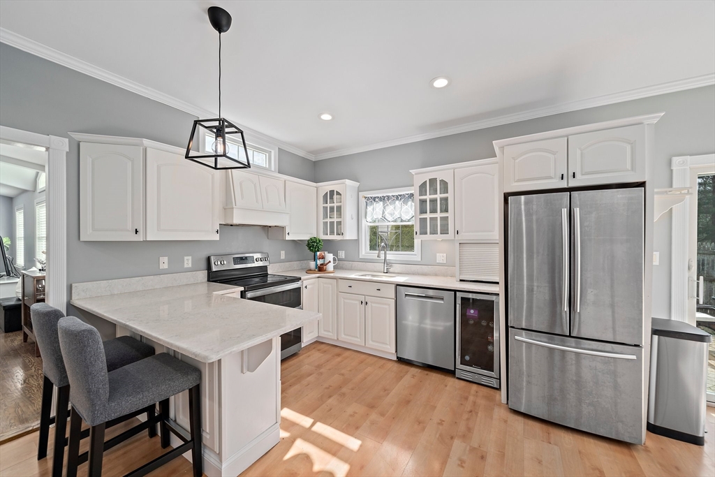 54 Birchcroft Road Canton, MA 02021 - Photo 17 of 37 a kitchen with a refrigerator a stove a sink and white cabinets