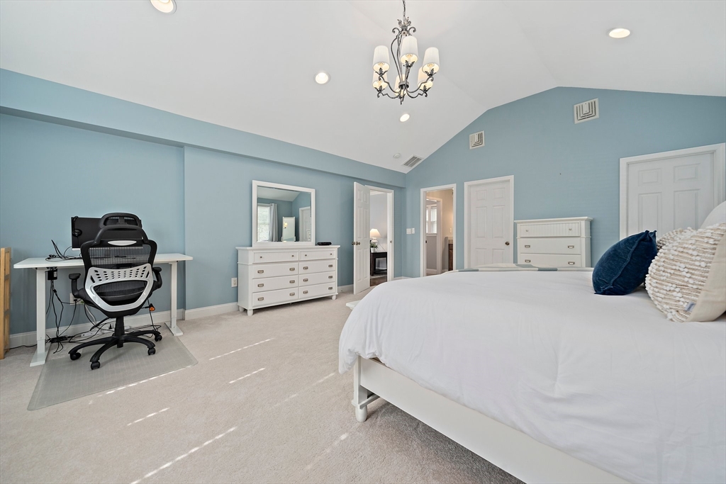 54 Birchcroft Road Canton, MA 02021 - Photo 26 of 37 a spacious bedroom with a bed a chandelier and a chair