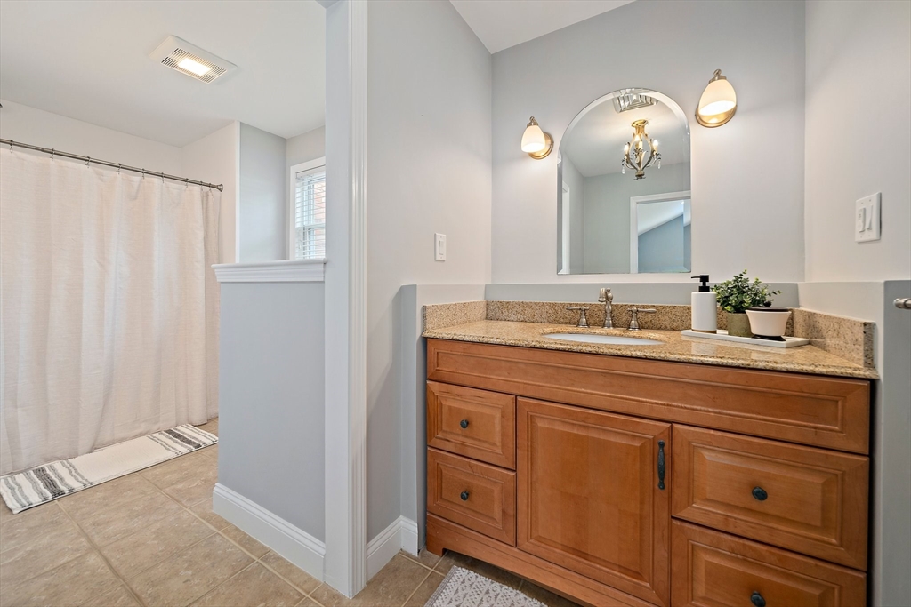 54 Birchcroft Road Canton, MA 02021 - Photo 27 of 37 a bathroom with a double vanity sink and mirror