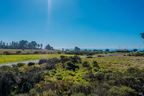 a view of a lake with houses in the back