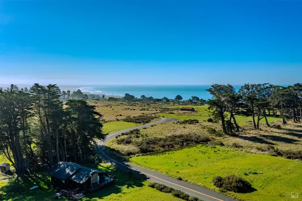 a view of a yard with an outdoor seating and mountain view in back