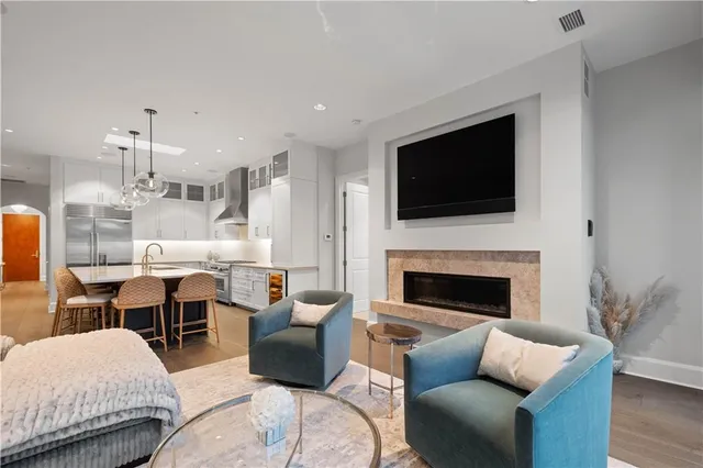 a living room with furniture fireplace and flat screen tv