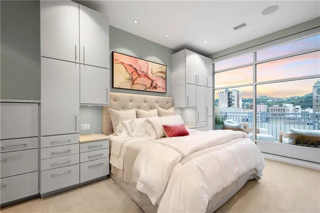 a bedroom with a large bed and a large window