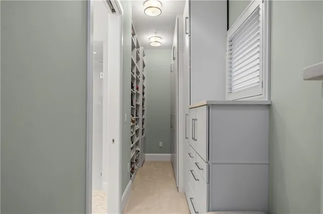 a spacious bathroom with a double vanity sink a large mirror and shower