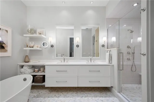 a bathroom with a double vanity sink toilet and shower