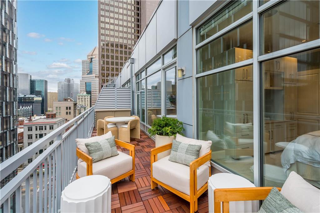 301 Fifth Avenue, Unit 720 Pittsburgh, PA 15222 - Photo 3 of 49 a balcony with wooden floor and outdoor seating