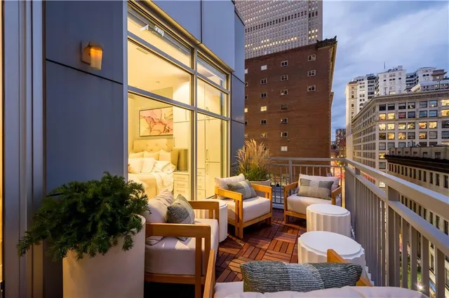 a view of balcony with a potted plant and outdoor seating