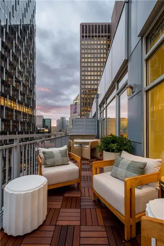 a view of a balcony with a couch and wooden floor