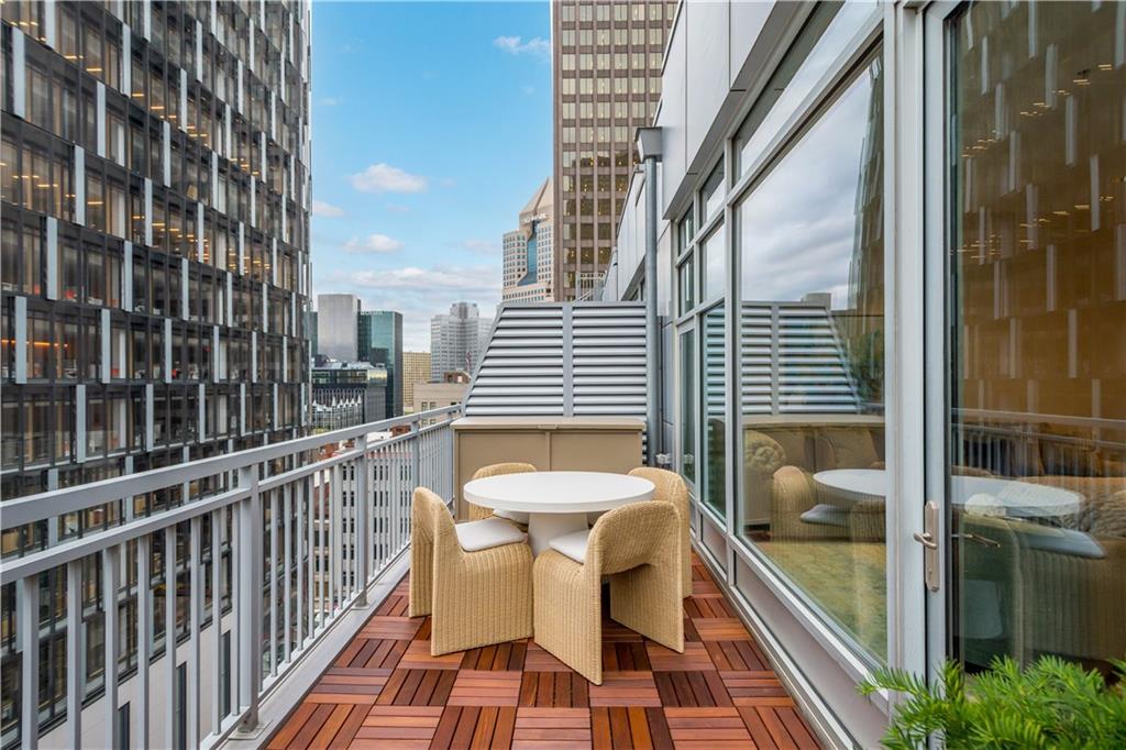 301 Fifth Avenue, Unit 720 Pittsburgh, PA 15222 - Photo 37 of 49 a view of a balcony with a couch and wooden floor