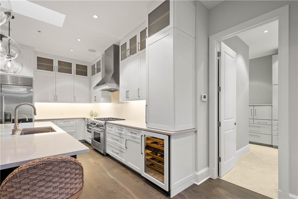 301 Fifth Avenue, Unit 720 Pittsburgh, PA 15222 - Photo 7 of 49 a kitchen with stainless steel appliances granite countertop a sink and a stove with white countertops