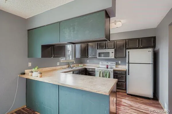 a kitchen with a refrigerator and a sink