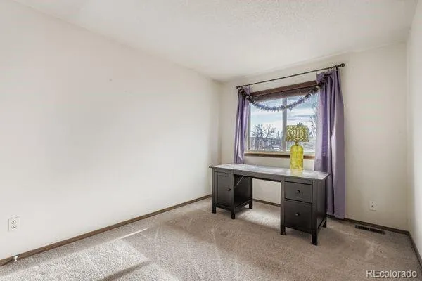 a room with chair table and a window