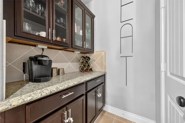 a kitchen with granite countertop stainless steel appliances a sink and cabinets