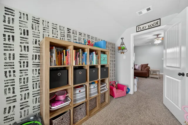 a living room with furniture and a book shelf