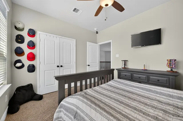 a bedroom with a bed and flat screen tv