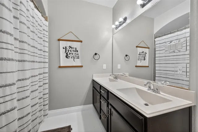 a bathroom with a sink a mirror and a shower