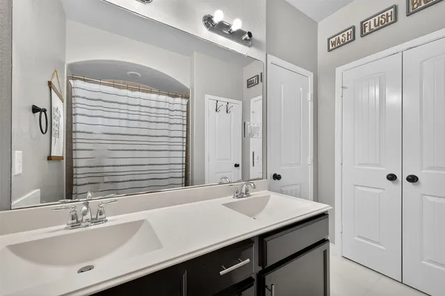a bathroom with a sink double vanity and a mirror