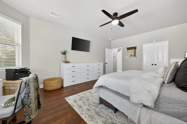 a bedroom with a bed and a television