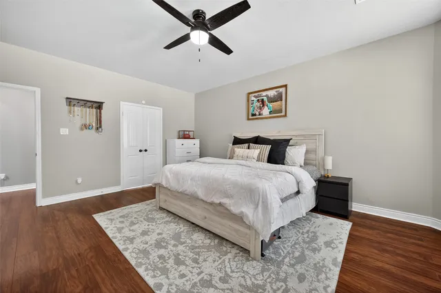 a bedroom with a bed and wooden floor