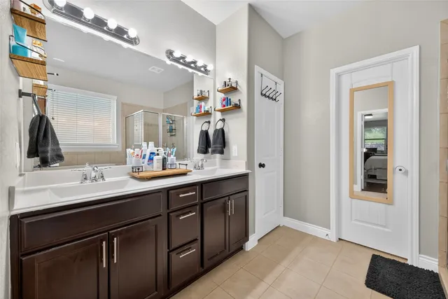 a bathroom with a sink double vanity and a mirror