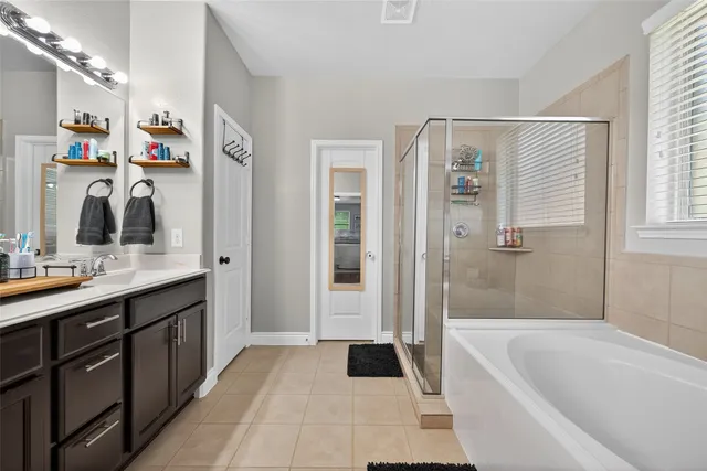 a bathroom with a tub sink and mirror
