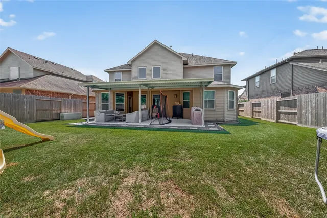 a view of a house with a backyard porch and sitting area