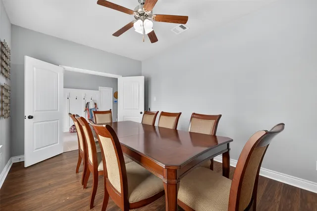 a view of a dining room with furniture and wooden floor