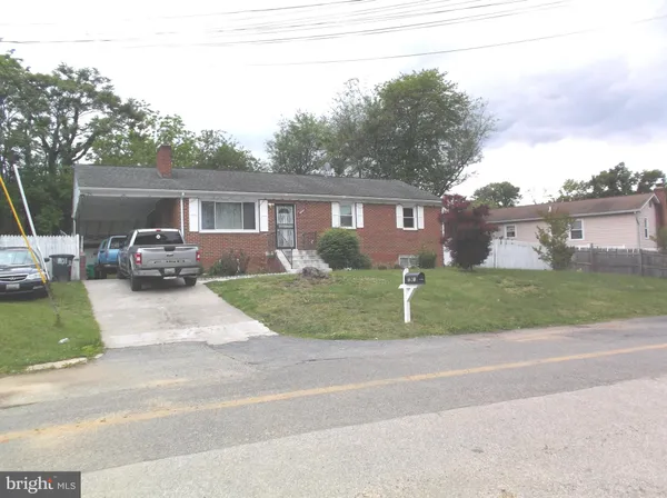 a front view of a house with a garden and plants
