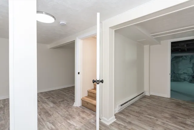 a view of a room with wooden floor and bathroom