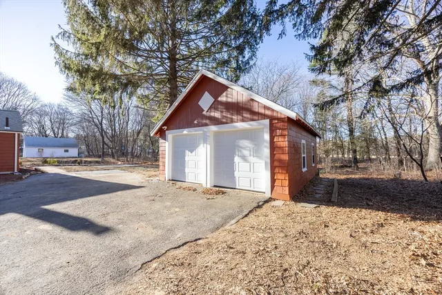 a front view of a house with a yard covered in snow