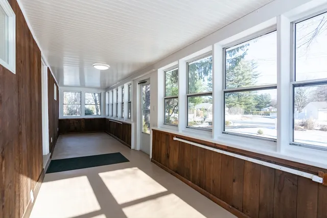 a view of hallway with a large window and furniture