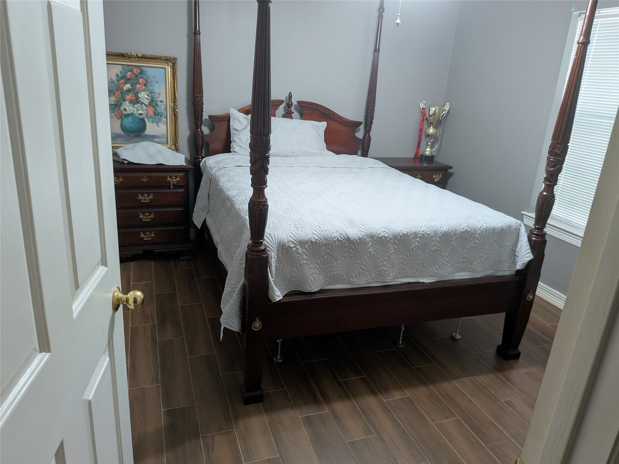 13107 Walnut Lake Road Houston, TX 77065 - Photo 14 of 23 a bed sitting in a bedroom next to a wooden floor