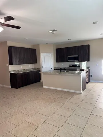 a kitchen with stainless steel appliances a stove a microwave and a sink